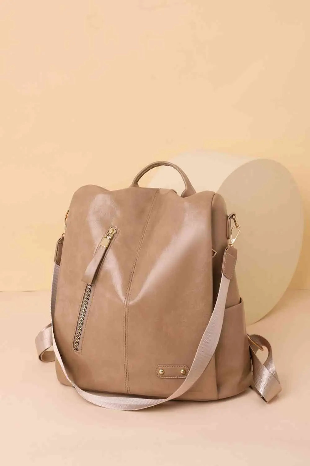 Marcy Zipper Pocket Backpack in beige with sleek design and multiple pockets for stylish urban adventures.